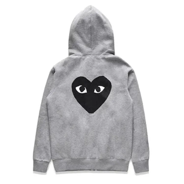 There is a big black heart behind the gray cardigan with looped fur